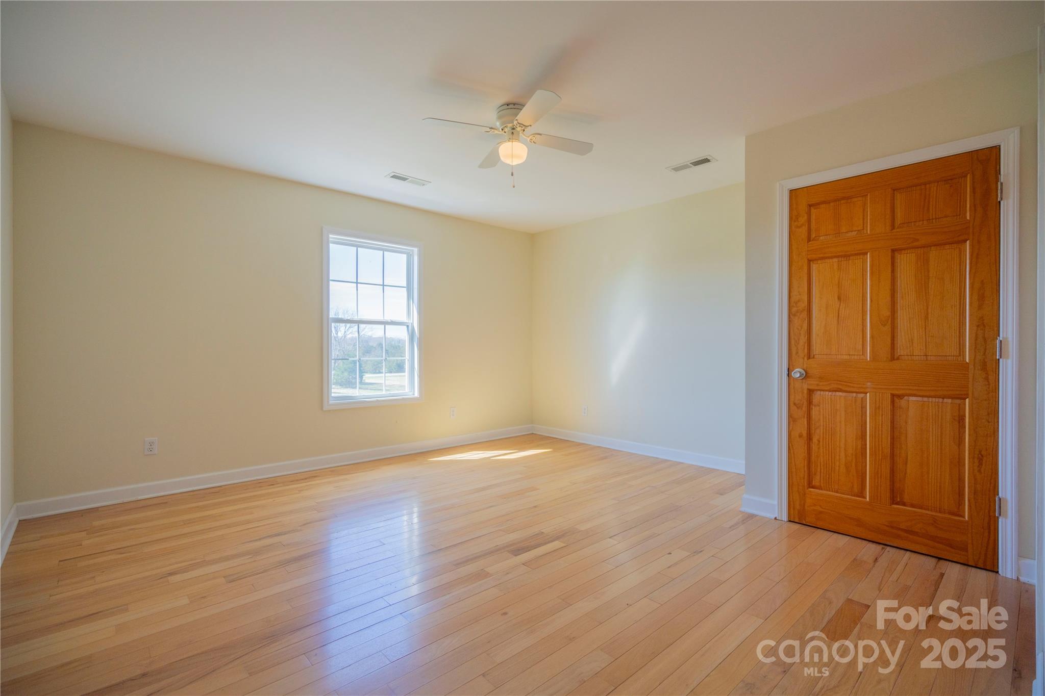 2536 Tyro Road Lexington, NC 27295 - Photo 8 of 31 a view of an empty room with wooden floor and a window