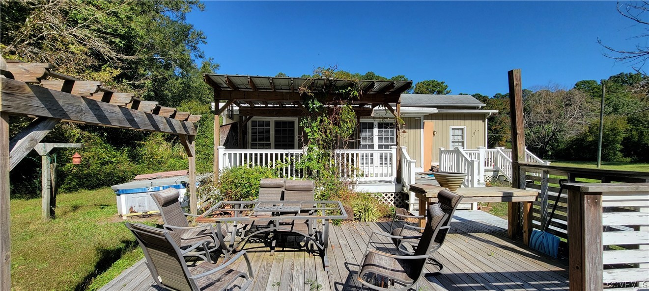 3502 Goodwin Neck Road Yorktown, VA 23692 - Photo 19 of 23 a view of a patio with table and chairs and potted plants