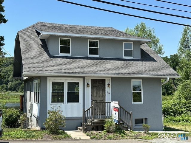 135 Middlesex Avenue Chester, CT 06412 - Photo 2 of 34 a front view of a house with yard