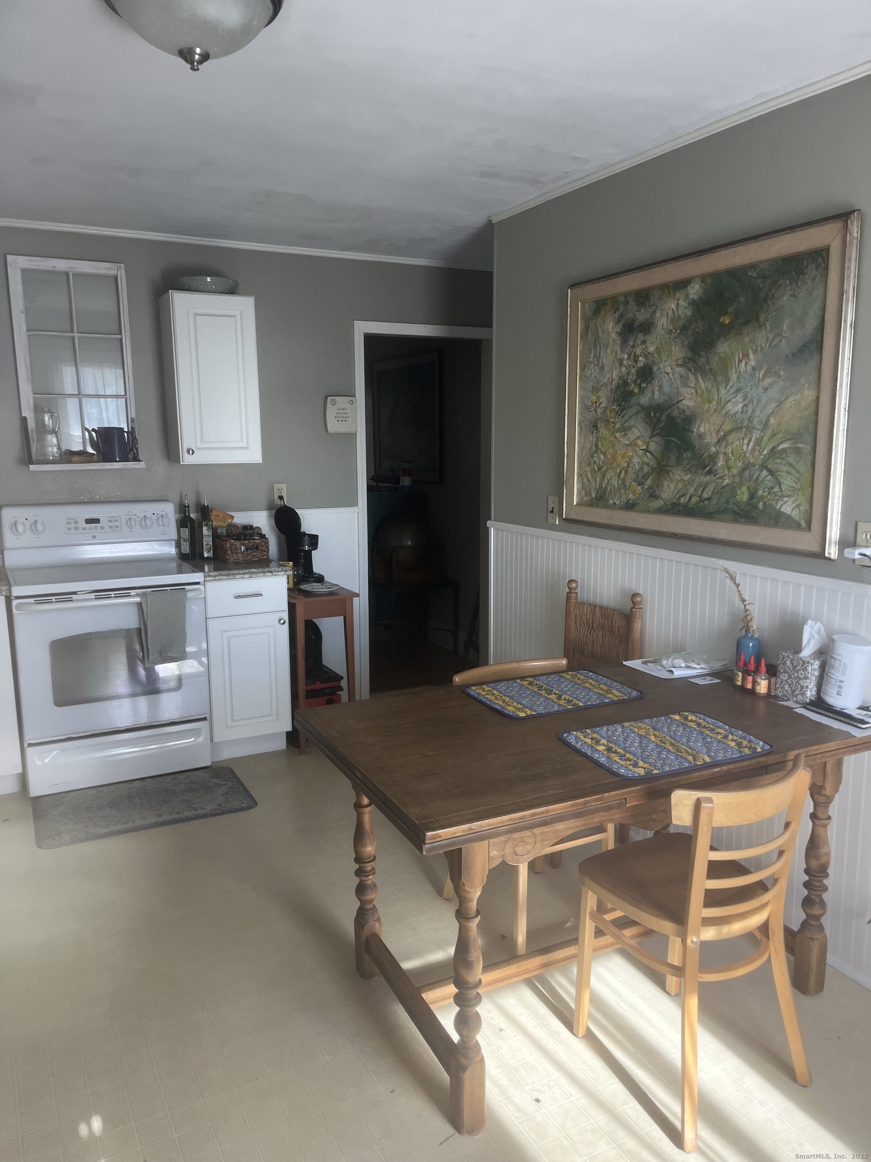 83 Ledyard Avenue Groton, CT 06340 - Photo 13 of 15 a dining room with a stove and a table