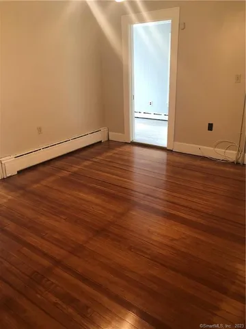 an empty room with wooden floor