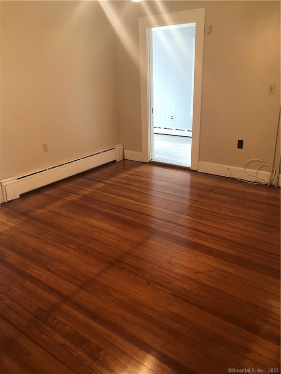 83 Ledyard Avenue Groton, CT 06340 - Photo 8 of 15 an empty room with wooden floor