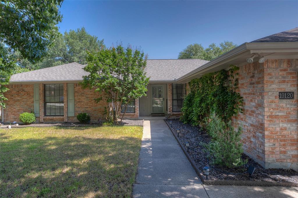 a view of a house with a yard and a patio