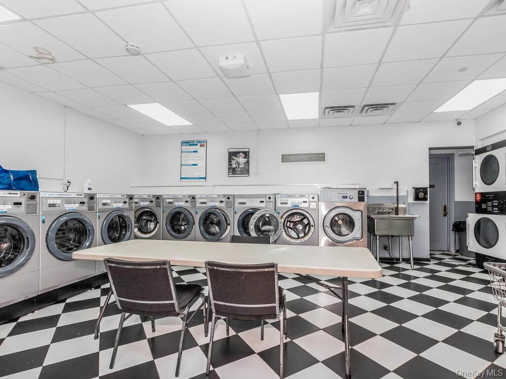 340 West 57th Street, Unit 5F Manhattan, NY 10019 - Photo 14 of 24 a utility room with dryer washer and a view of living room