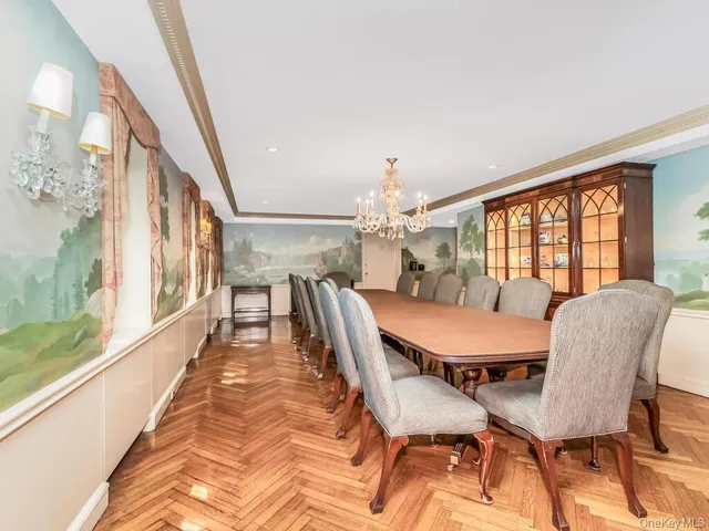 a view of a dining room with furniture a chandelier and wooden floor