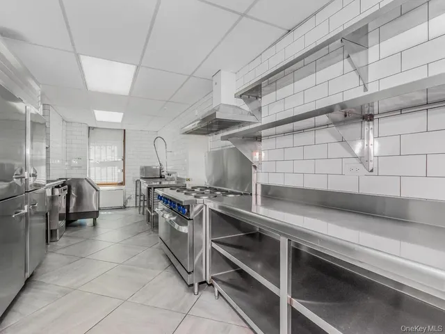 a kitchen with stainless steel appliances granite countertop a sink and a stove