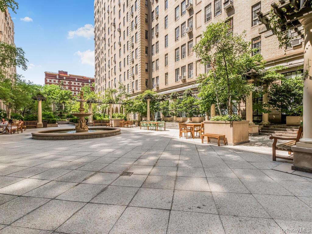 340 West 57th Street, Unit 5F Manhattan, NY 10019 - Photo 23 of 24 a view of a building with bench and trees