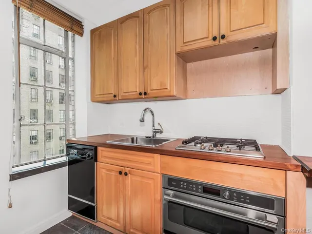 a kitchen with granite countertop a stove and a sink