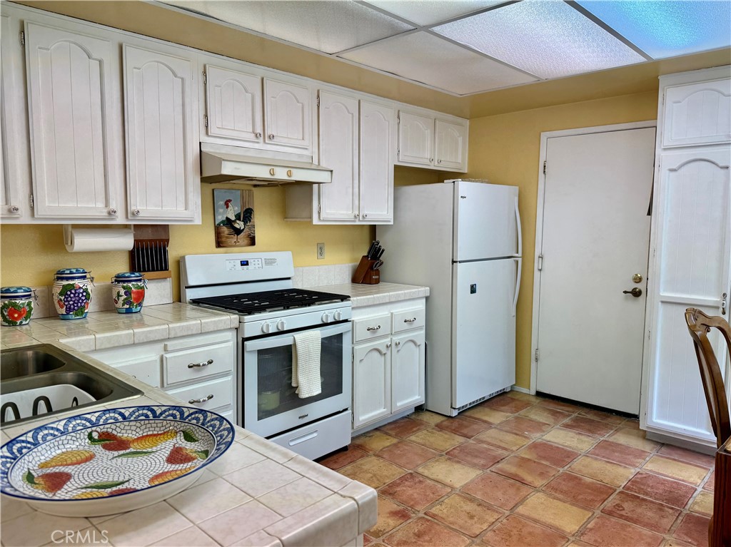 8 Coldstream Irvine, CA 92604 - Photo 8 of 27 a kitchen with a stove a refrigerator and a sink