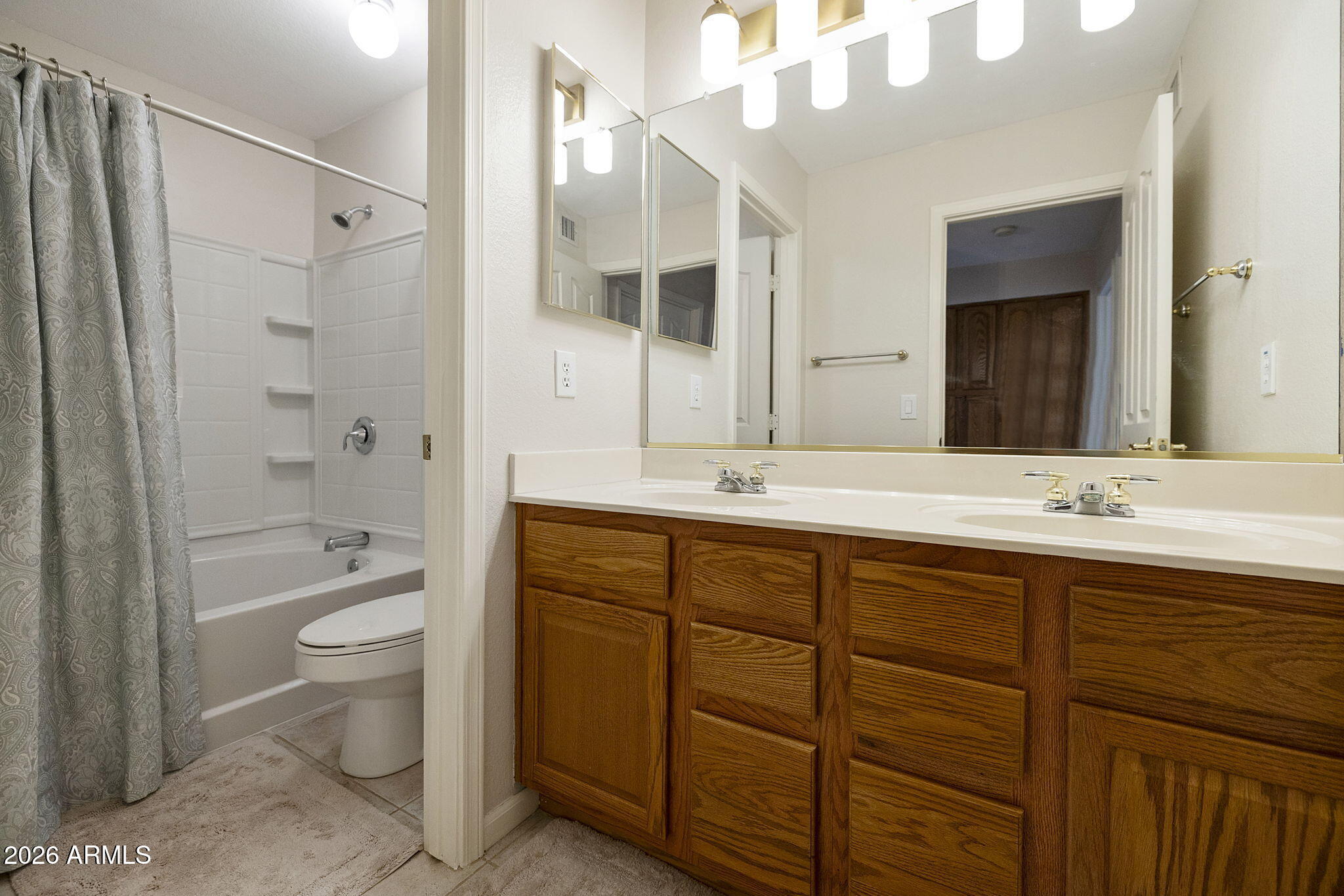 12435 West Monte Vista Road Avondale, AZ 85392 - Photo 29 of 69 a bathroom with a double vanity sink toilet mirror and shower