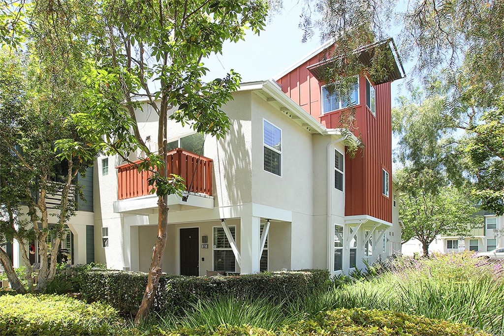 52 Palladium Lane, Unit 82 Ladera Ranch, CA 92694 - Photo 1 of 20 a view of a white house with a large windows and a yard with plants and large trees