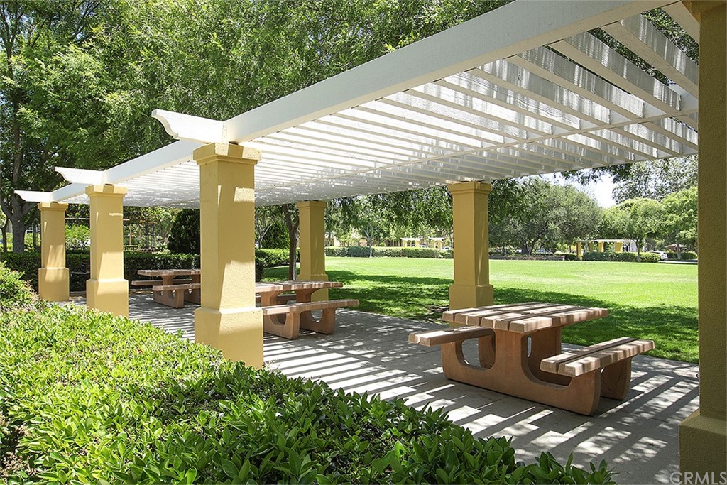 52 Palladium Lane, Unit 82 Ladera Ranch, CA 92694 - Photo 19 of 20 a view of a patio with table and chairs potted plants with large tree