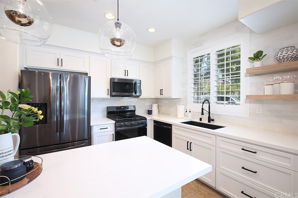 52 Palladium Lane, Unit 82 Ladera Ranch, CA 92694 - Photo 2 of 20 a kitchen with a refrigerator and a sink