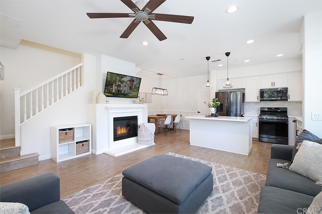 52 Palladium Lane, Unit 82 Ladera Ranch, CA 92694 - Photo 20 of 20 a living room with furniture a fireplace and a flat screen tv
