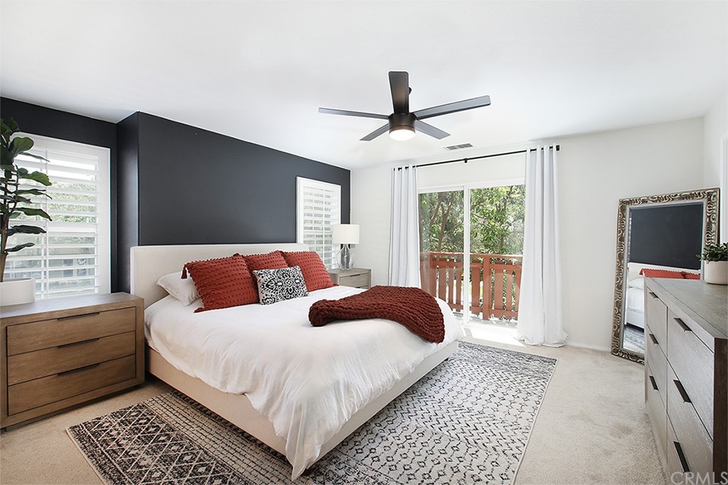 52 Palladium Lane, Unit 82 Ladera Ranch, CA 92694 - Photo 7 of 20 a bedroom with a large bed a flat tv screen and a dresser