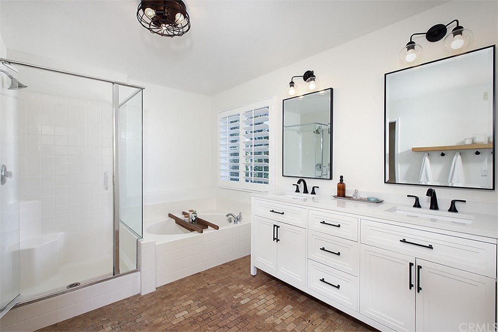 52 Palladium Lane, Unit 82 Ladera Ranch, CA 92694 - Photo 9 of 20 a bathroom with a double vanity sink mirror double and shower