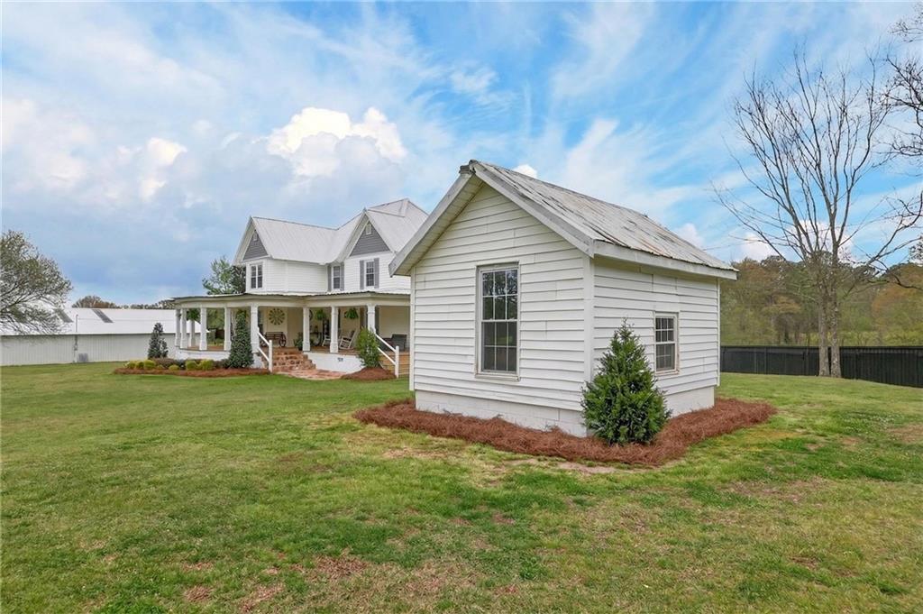 3590 Roosterville Road Roopville, GA 30170 - Photo 7 of 66 a front view of a house with a garden