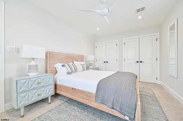 a bedroom with a bed and a night stand