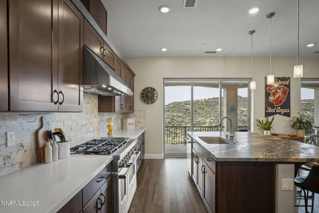 a kitchen with a sink and a stove top oven