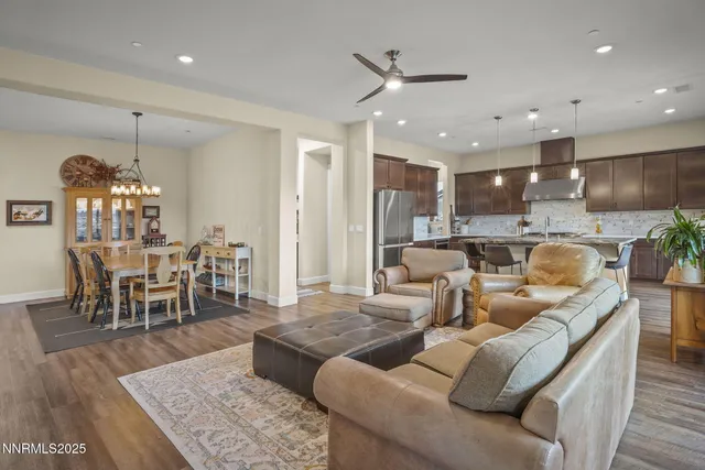 a kitchen with stainless steel appliances granite countertop a sink refrigerator and cabinets