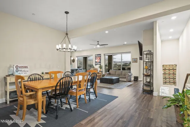 a kitchen with granite countertop kitchen island wooden floor center island and stainless steel appliances