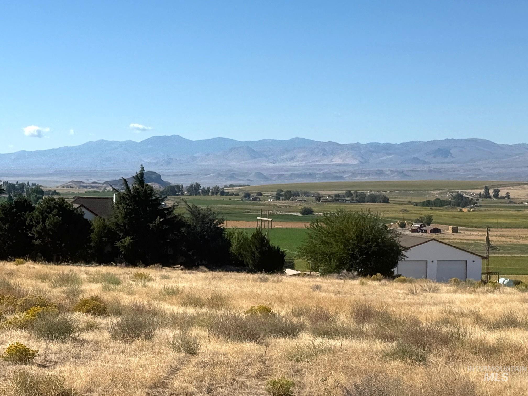 View of mountain backdrop featuring rural landscape