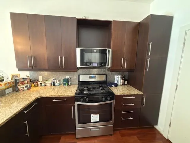 a kitchen with a stove and a microwave