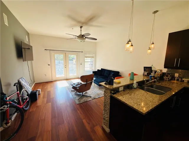 a view of a workspace with furniture and wooden floor