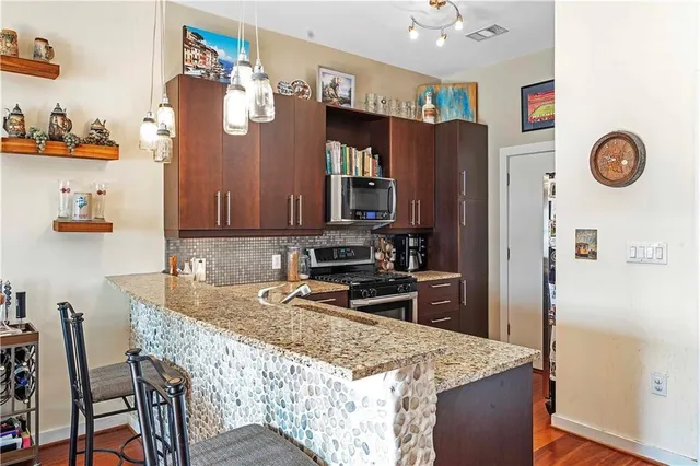 a kitchen with granite countertop cabinets and refrigerator
