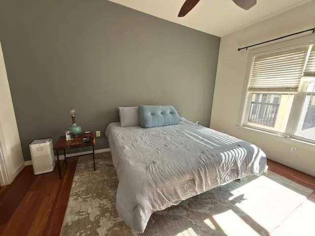 a bedroom with a bed and wooden floor