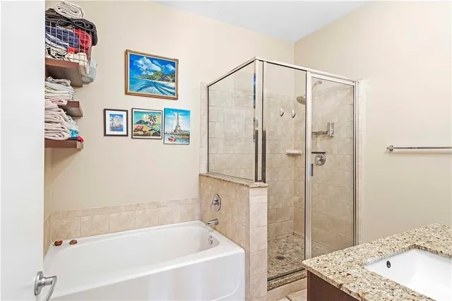 a bathroom with a tub a sink and shower