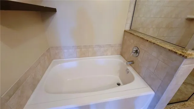 a white bath tub sitting in a bathroom