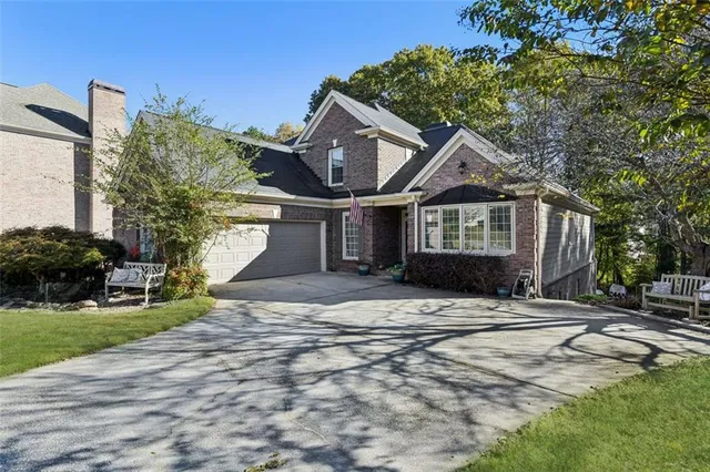 a front view of a house with a garden