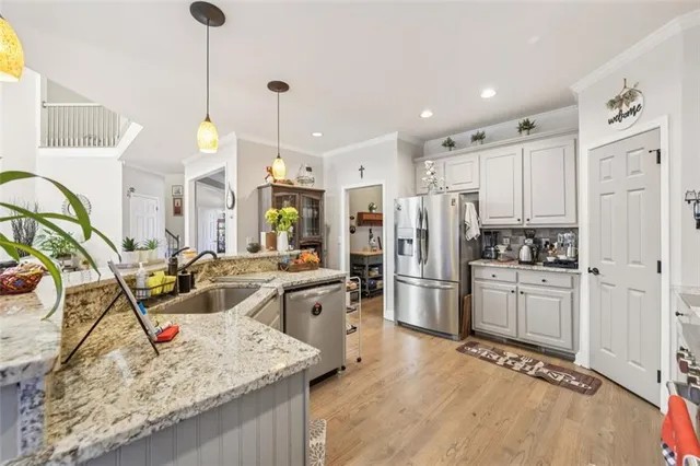 a spacious bedroom with a bed a couch and a chandelier