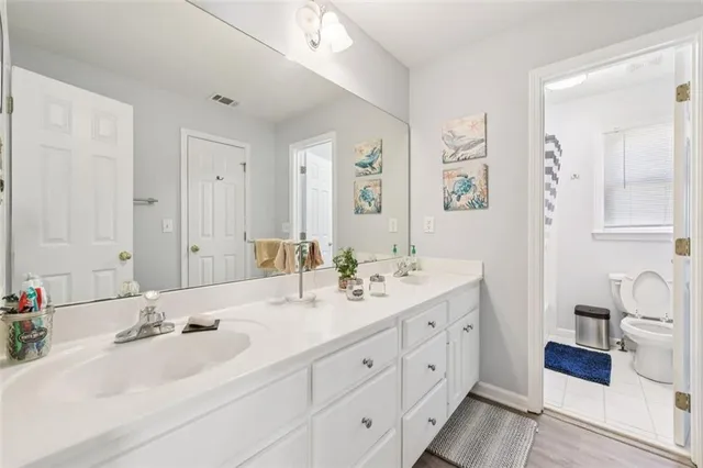 a living room with furniture a desk and chair with potted plants