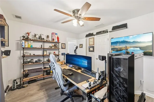 a front view of a house with a yard and large trees