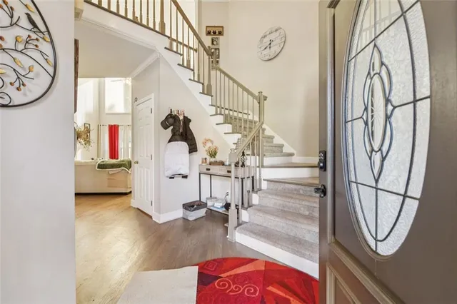 a living room with furniture a rug and a clock