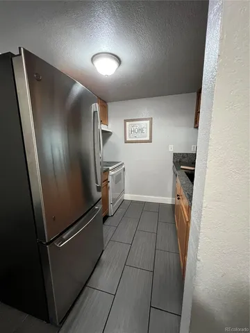 an empty room with fireplace and windows