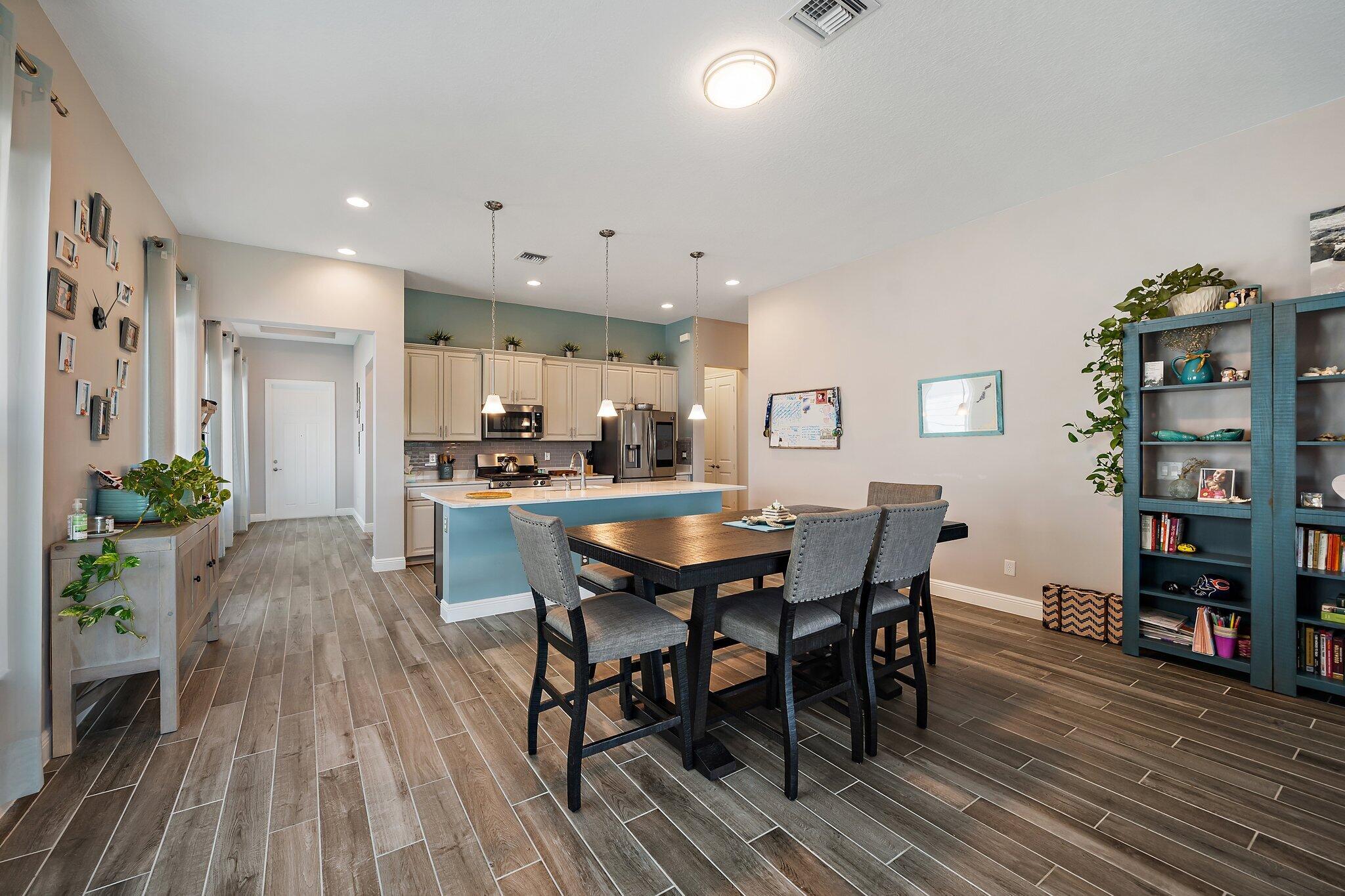 19540 Wheelbarrow Bend Loxahatchee, FL 33470 - Photo 12 of 54 a dining room with furniture and wooden floor