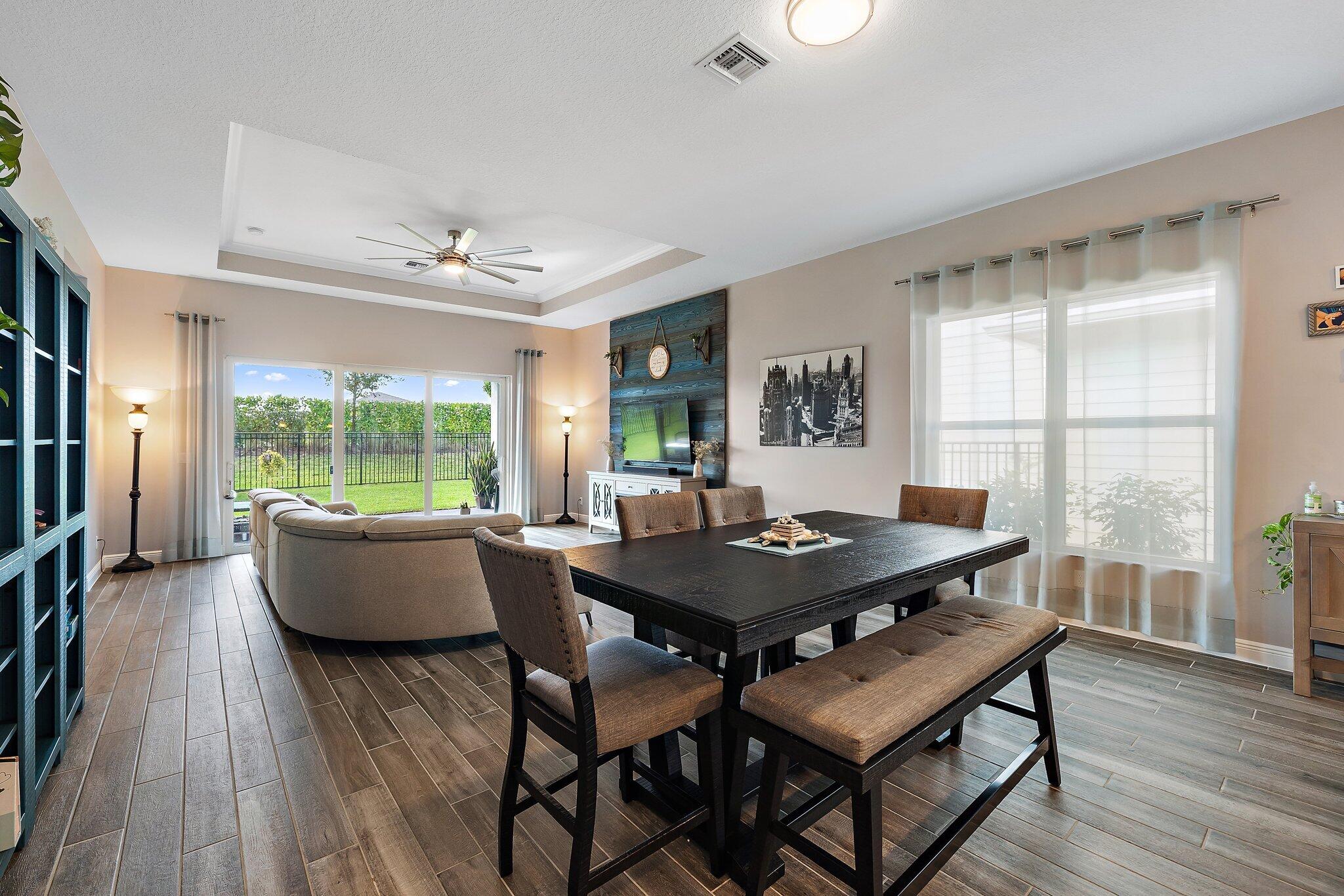 19540 Wheelbarrow Bend Loxahatchee, FL 33470 - Photo 13 of 54 a dining room with furniture and wooden floor