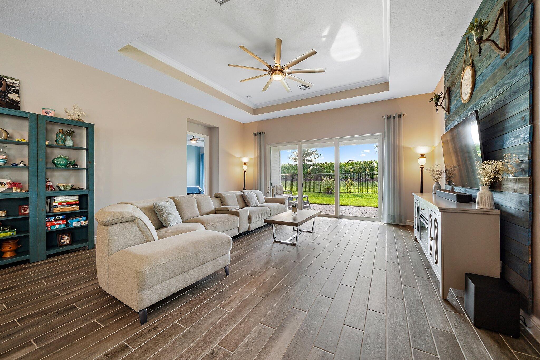 19540 Wheelbarrow Bend Loxahatchee, FL 33470 - Photo 14 of 54 a living room with furniture large window and wooden floor