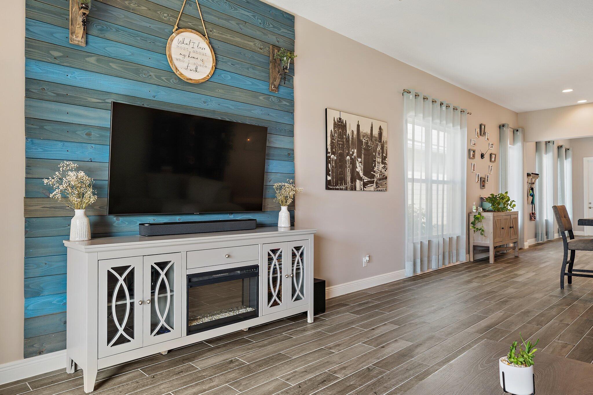19540 Wheelbarrow Bend Loxahatchee, FL 33470 - Photo 17 of 54 a living room with furniture a flat screen tv and a fireplace
