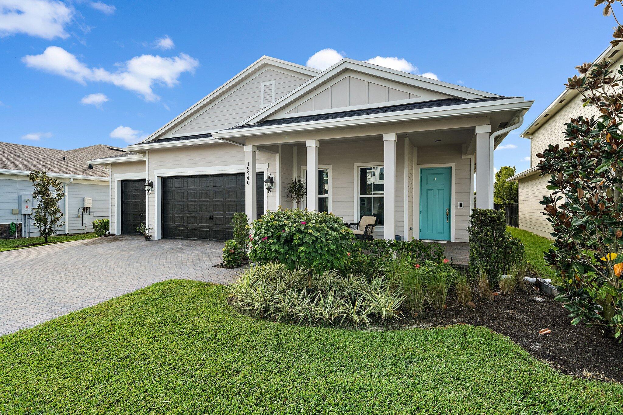 19540 Wheelbarrow Bend Loxahatchee, FL 33470 - Photo 2 of 54 a front view of a house with a yard
