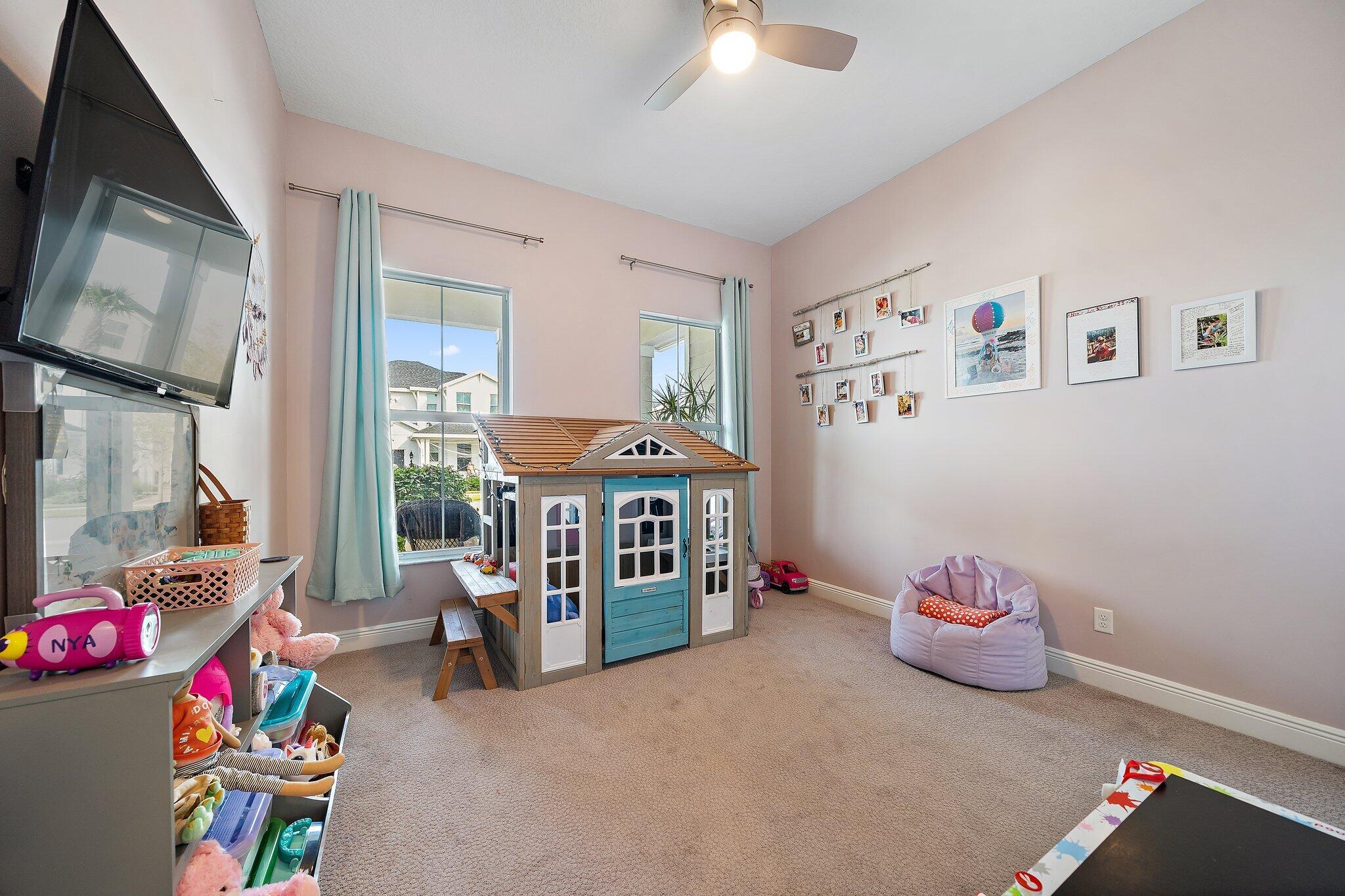 19540 Wheelbarrow Bend Loxahatchee, FL 33470 - Photo 21 of 54 a bedroom with furniture and a flat screen tv