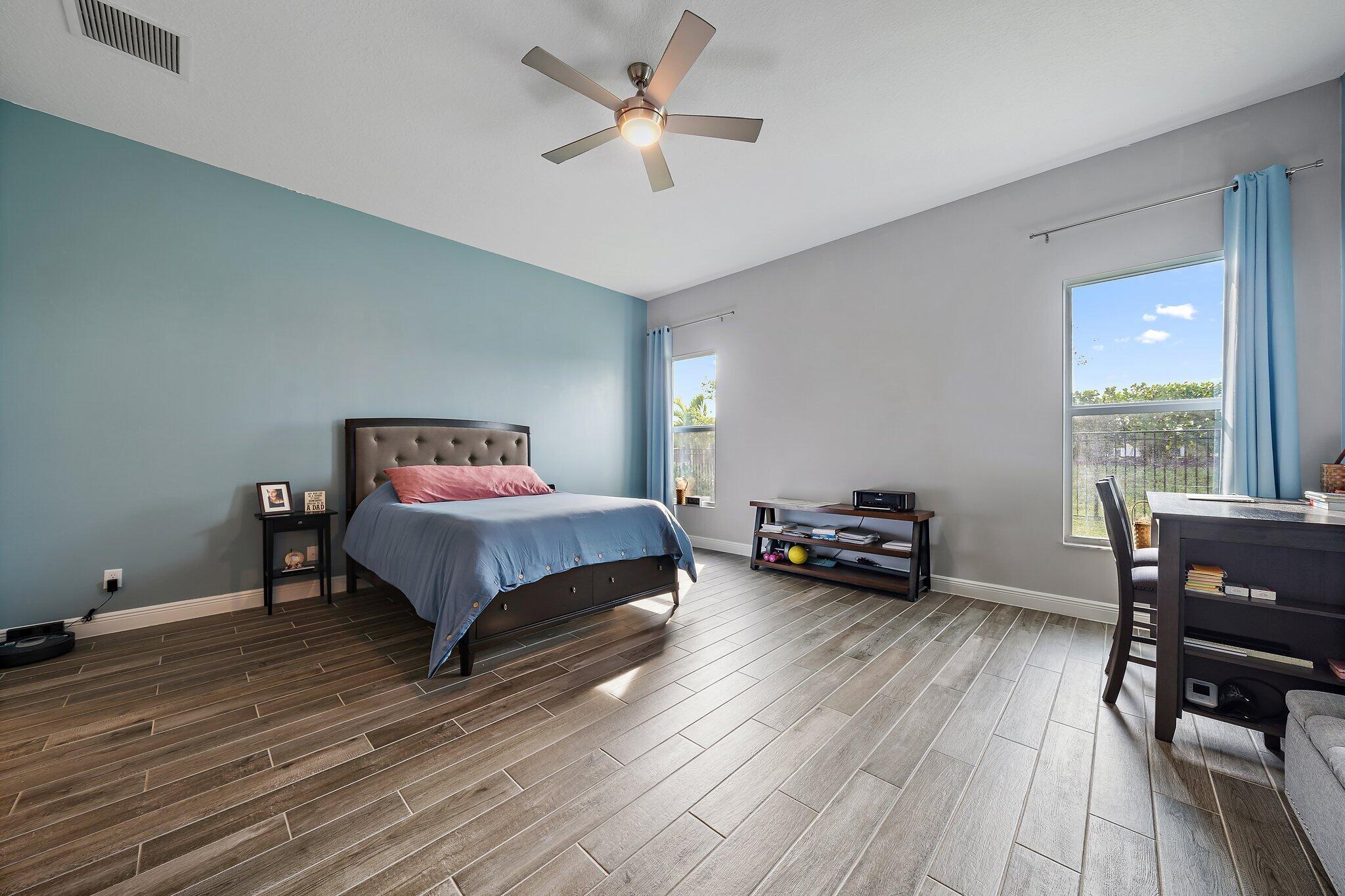 19540 Wheelbarrow Bend Loxahatchee, FL 33470 - Photo 26 of 54 a bed room with a bed and a chair