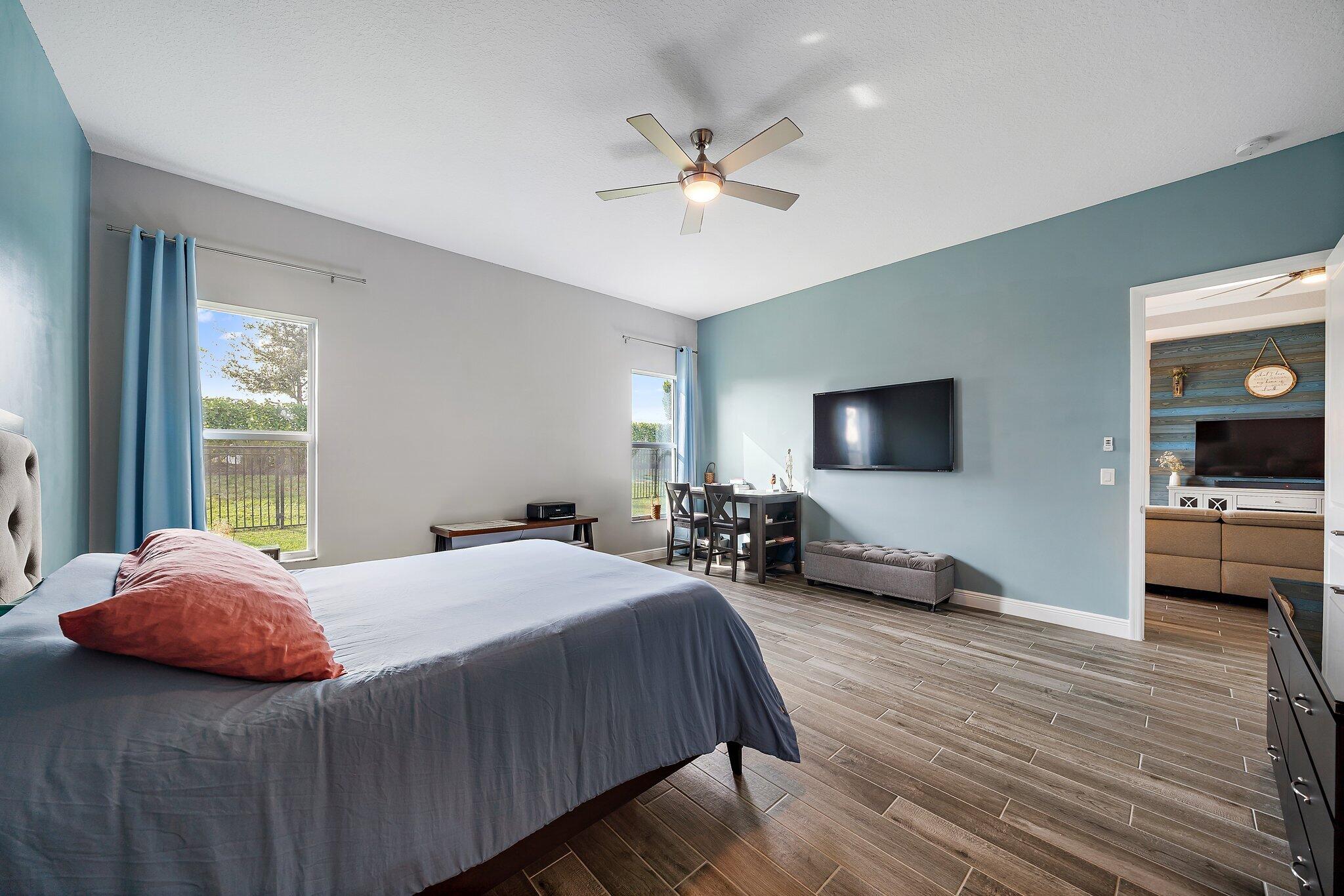 19540 Wheelbarrow Bend Loxahatchee, FL 33470 - Photo 27 of 54 a bedroom with a bed and a chandelier