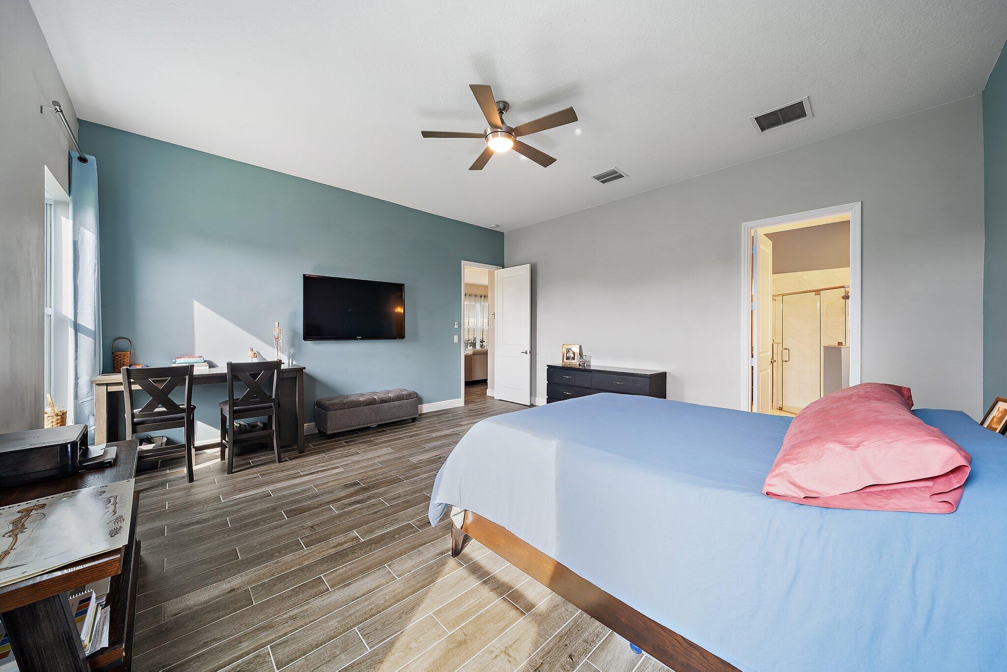 19540 Wheelbarrow Bend Loxahatchee, FL 33470 - Photo 28 of 54 a bedroom with a bed and flat screen tv