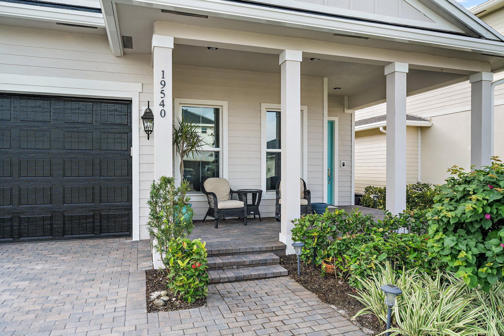 19540 Wheelbarrow Bend Loxahatchee, FL 33470 - Photo 3 of 54 a view of a entryway door of the house with outdoor seating