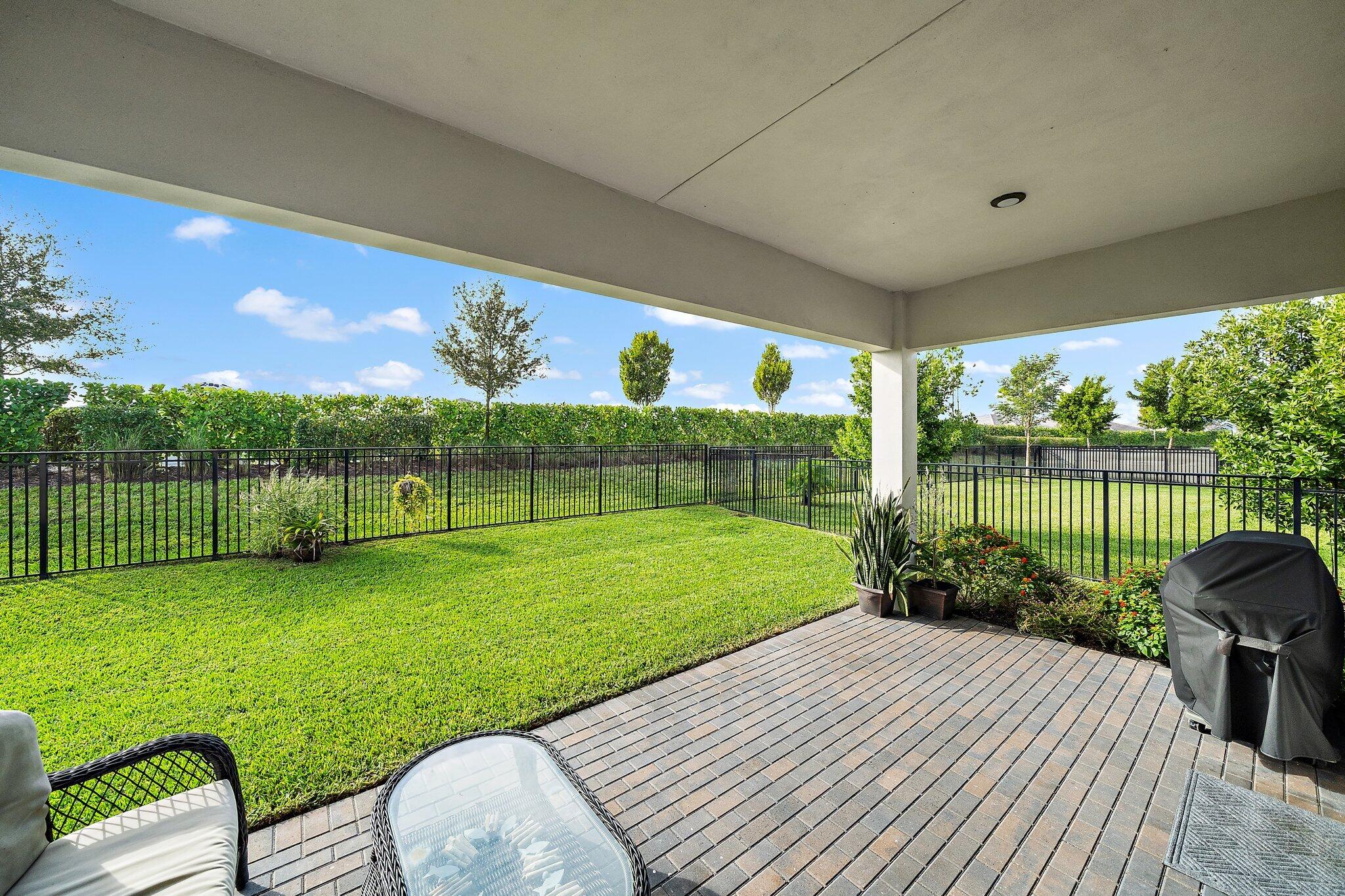 19540 Wheelbarrow Bend Loxahatchee, FL 33470 - Photo 34 of 54 a view of a backyard with sitting area