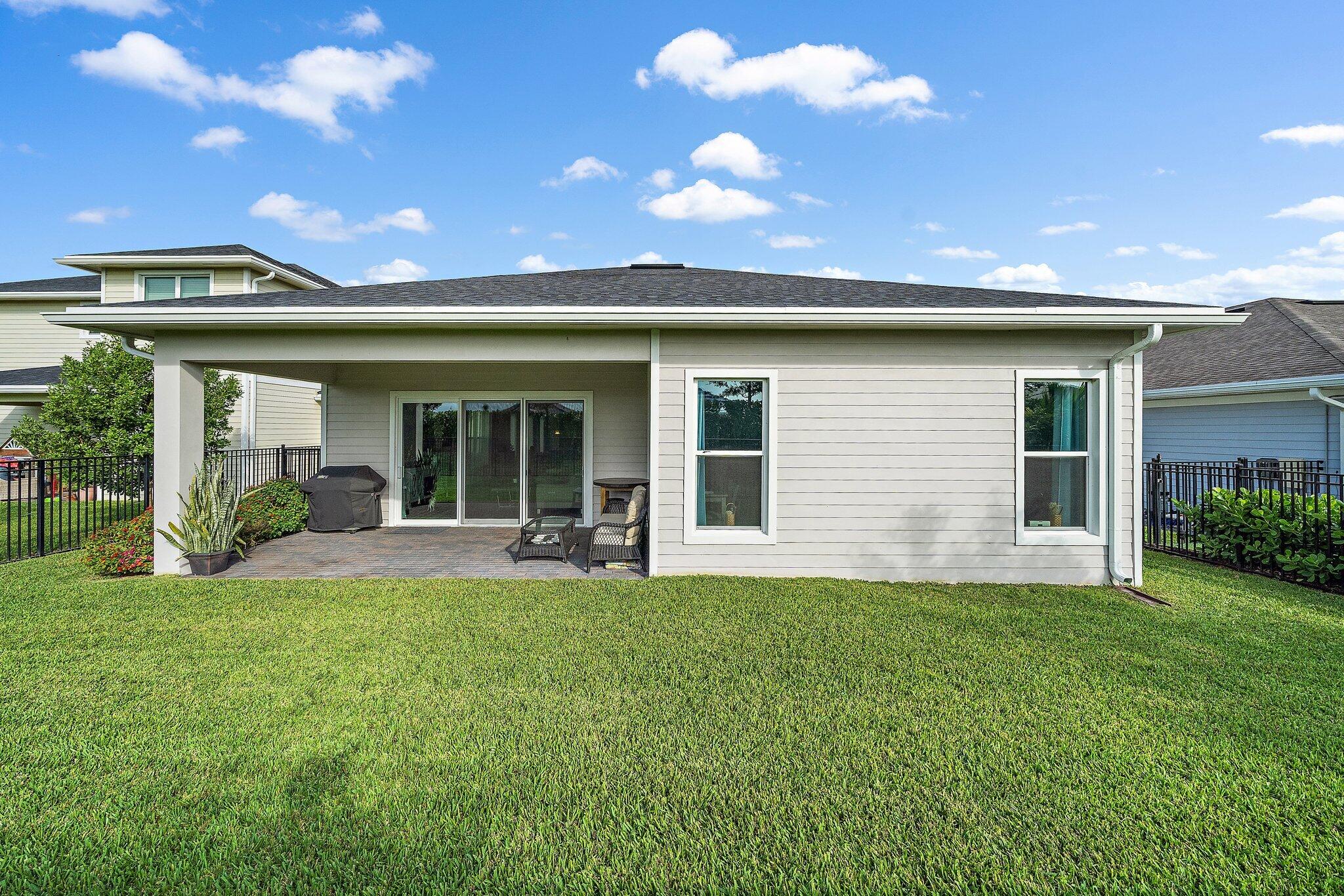 19540 Wheelbarrow Bend Loxahatchee, FL 33470 - Photo 37 of 54 a front view of a house with a garden and porch